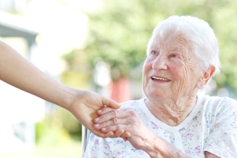 Older woman holding hands